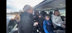 Ukrainian family loading into a van to cross the border